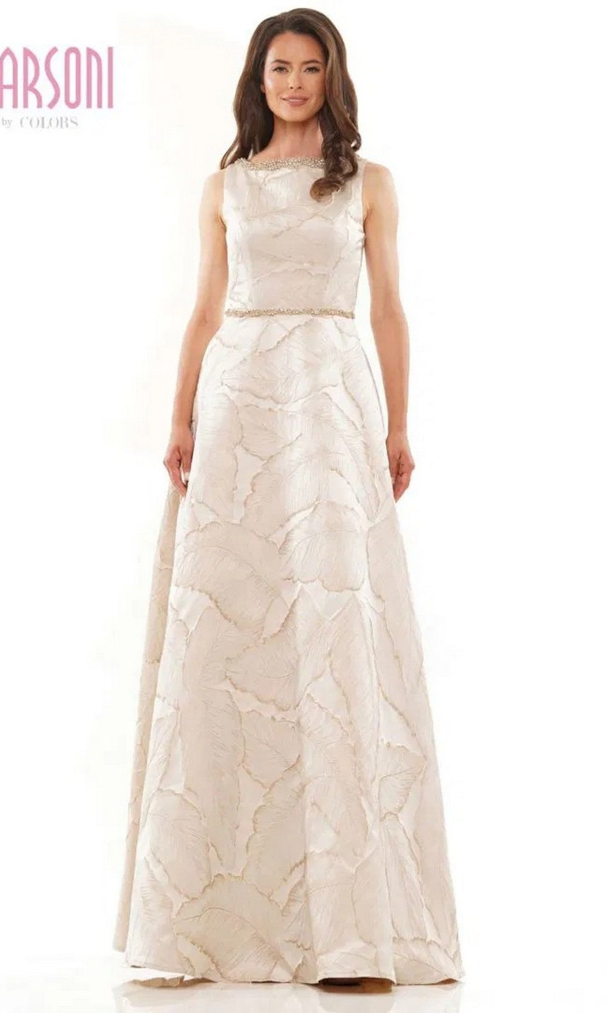 A woman models the Marsoni MV1224, a long formal sleeveless ivory gown featuring a fitted waist and subtle jacquard leaf pattern, set against a plain white background.